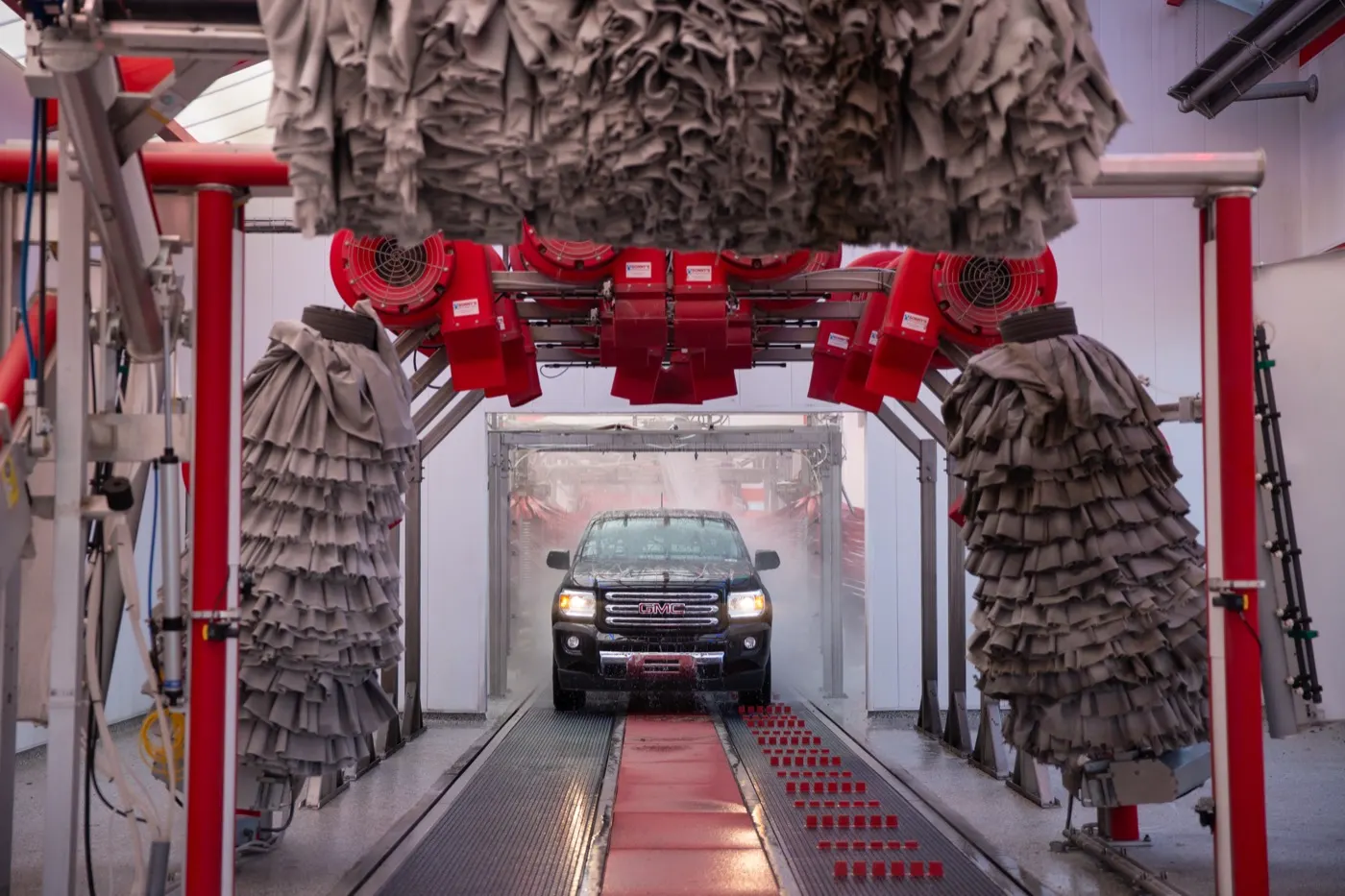 A truck rolling through the soft-foam wash tunnel at Kopetsky Auto Wash